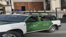 A police car leaves the courthouse on February 4, 2021 after accompanying one of the accused to the Algerian Dar Al-Baida Tribunal in the capital Algiers for a hearing in the case of the French mountain guide who was decapitated almost six years ago in Algeria. - Fourteen people are being prosecuted: 8 suspected kidnappers, the 5 Algerian hosts and companions of the Frenchman, as well as a man, Farjallah Amara, whose link to this case is not specified, according to a court document consulted by AFP. Gourdel, 55, was abducted on September 21, 2014 while exploring Djurdjura National Park, a draw for hikers but which has long been a sanctuary for jihadists. (Photo by RYAD KRAMDI / AFP)